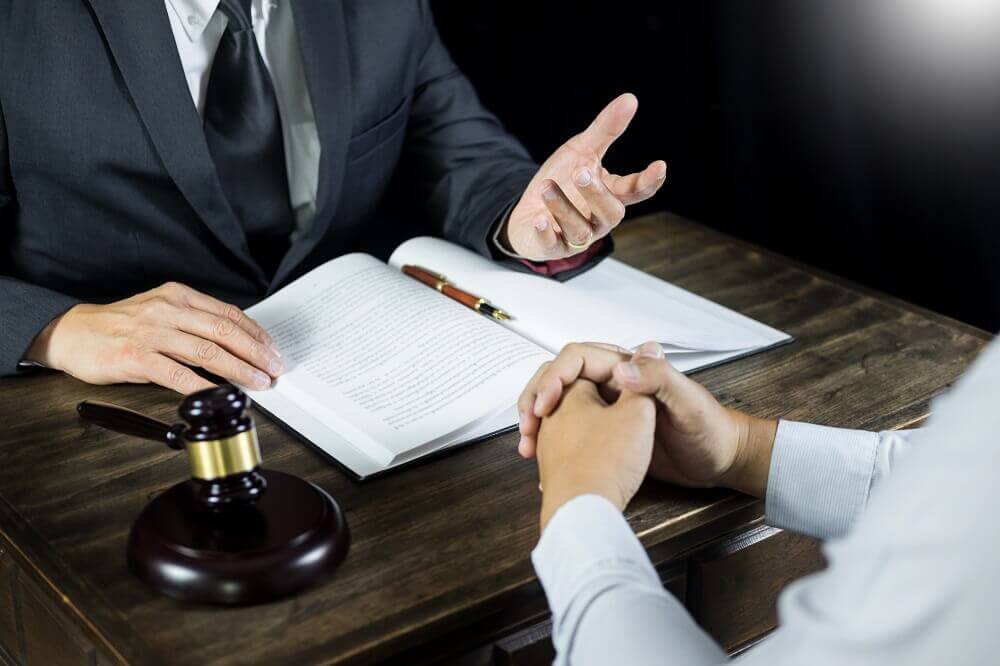 Personal injury lawyer discussing with his client.