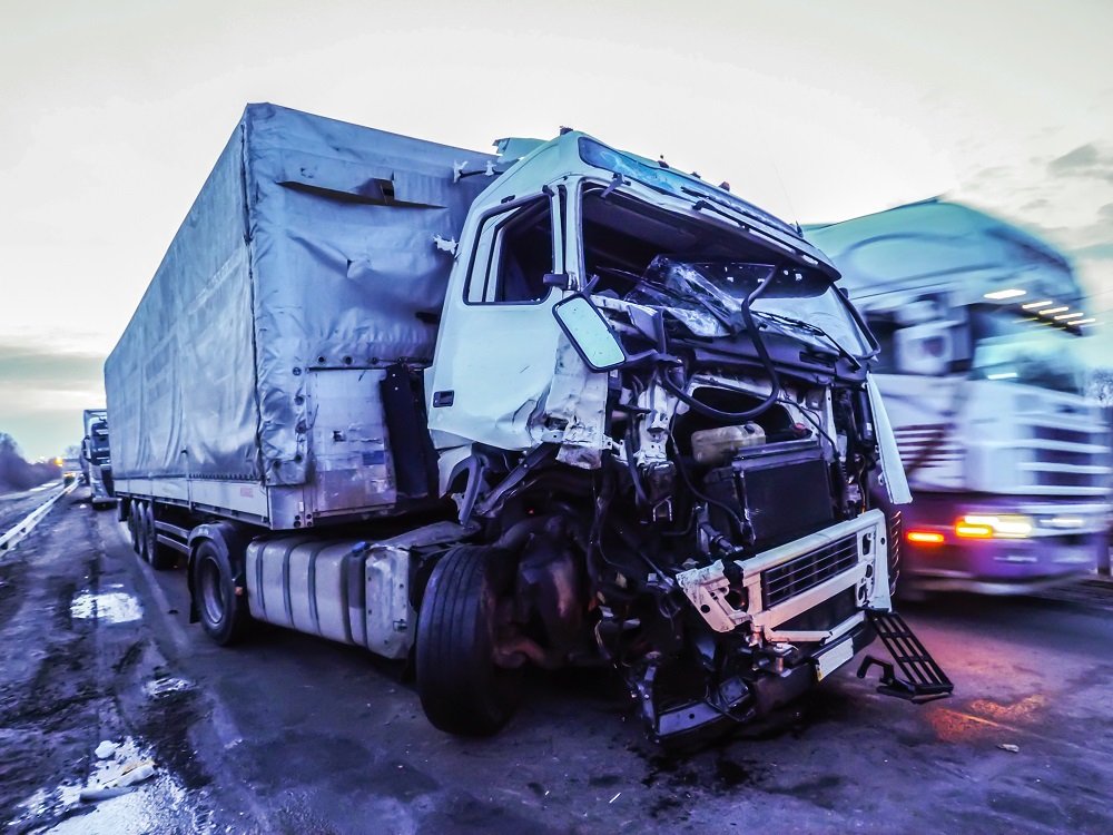 Truck accident happening along the highway.