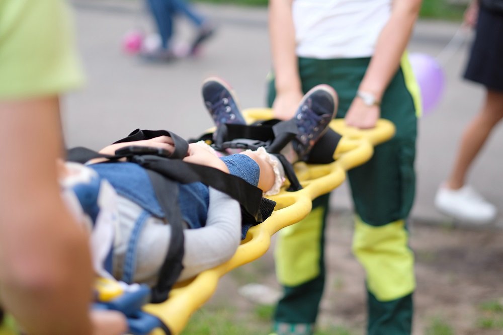 Paramedics team rescuing child injured from car accident.