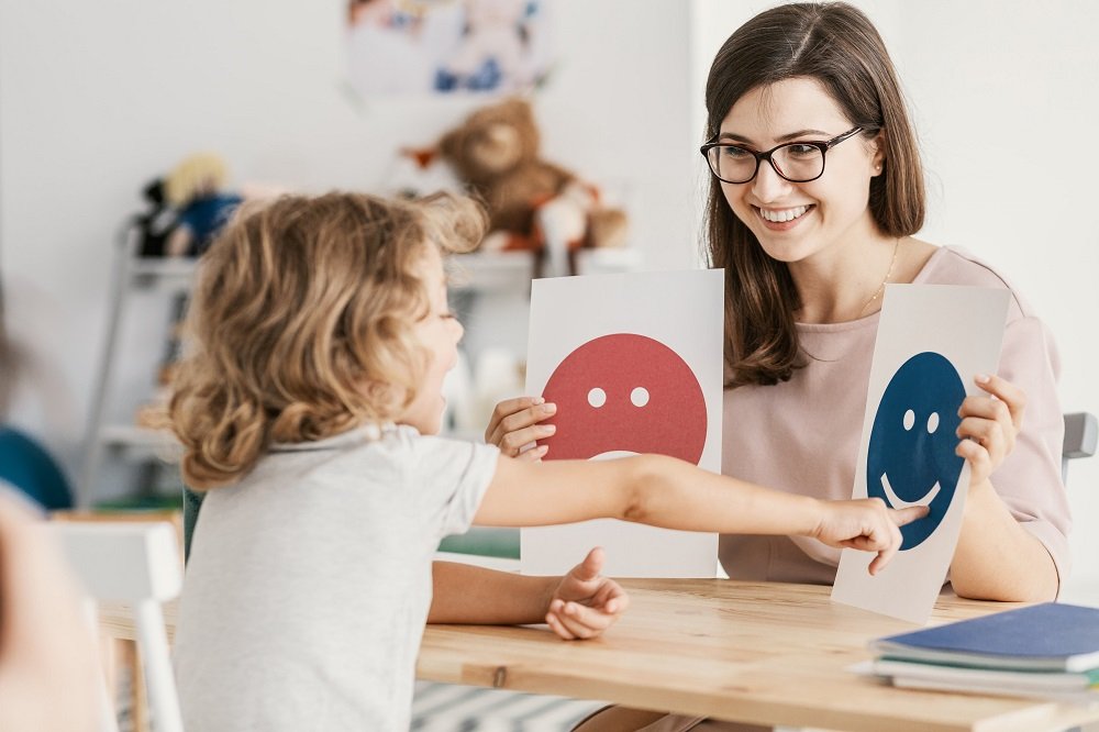 Child choosing smiley emoticons.