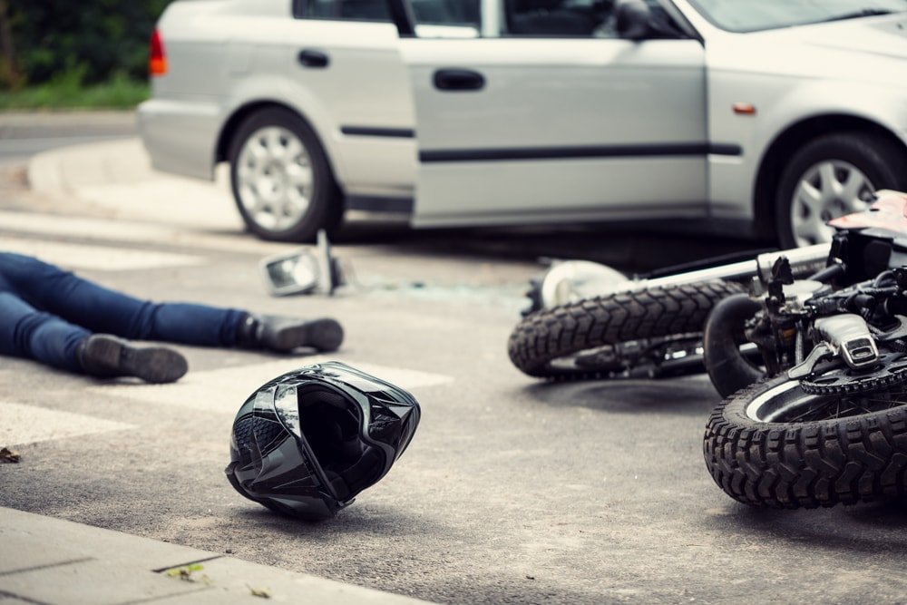 Man on motorcycle got hit by a car.