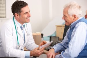 Doctor talking to a happy patient who qualified for workers compensation in Indiana.