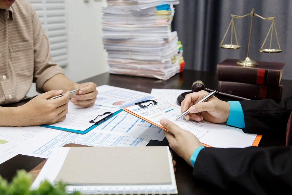 Stack of paper works in law office.