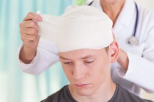 Young man with bandage experiencing trauma in accident.