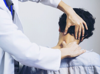 doctor checking a patient for a neck injury