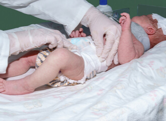 Newborn baby being examined by doctor