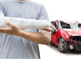 Man with a bandaged arm after suffering car accident injury