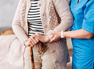 An older person being assisted in an Indiana nursing home.