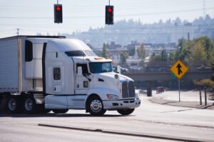 White truck driving on the highway.