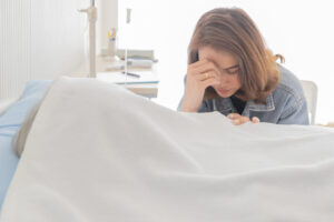 Daughter crying on the death of her father.