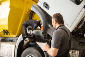 Truck adjuster checking on truck damages.