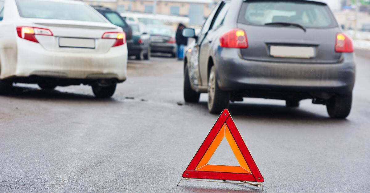 Car accidents in the middle of highway with caution sign