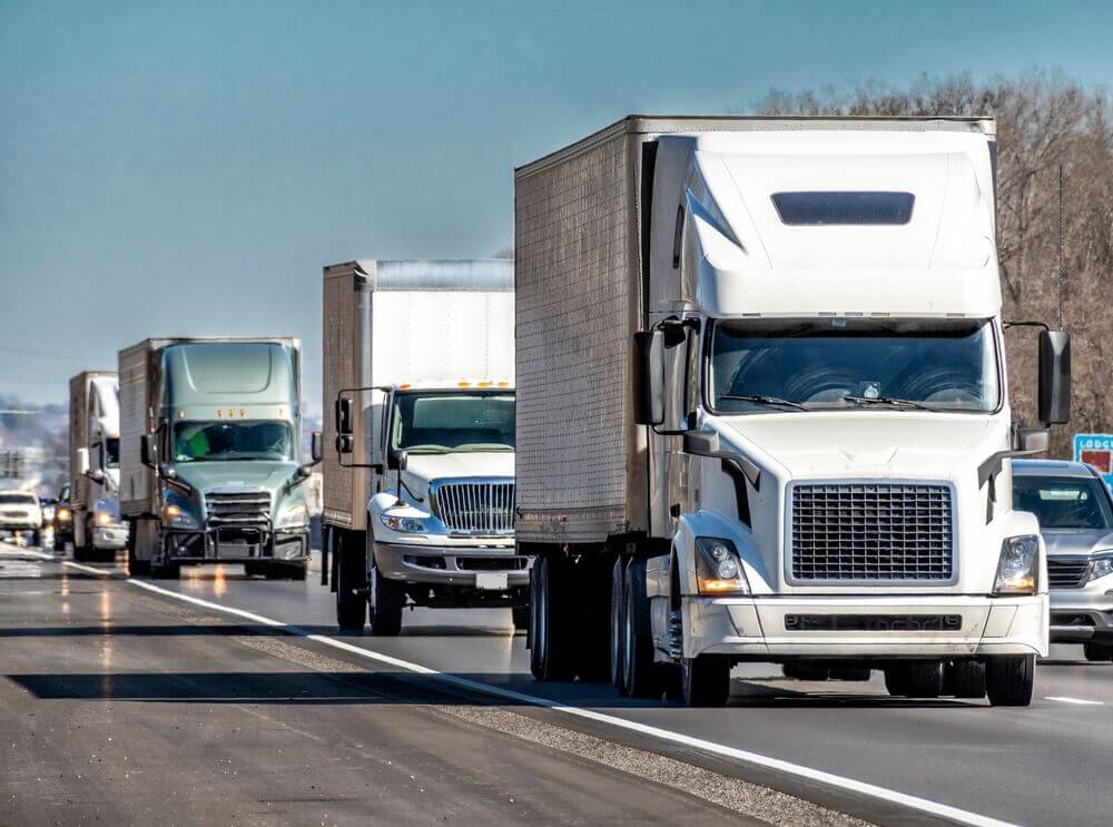 White truck passing in the highway.