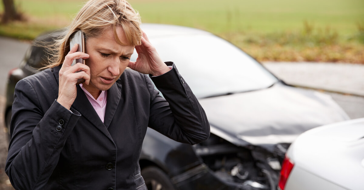 Female driver calling 911 and police to report accident.