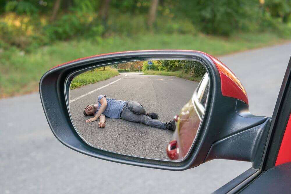 Male pedestrian got hit and run by red car.