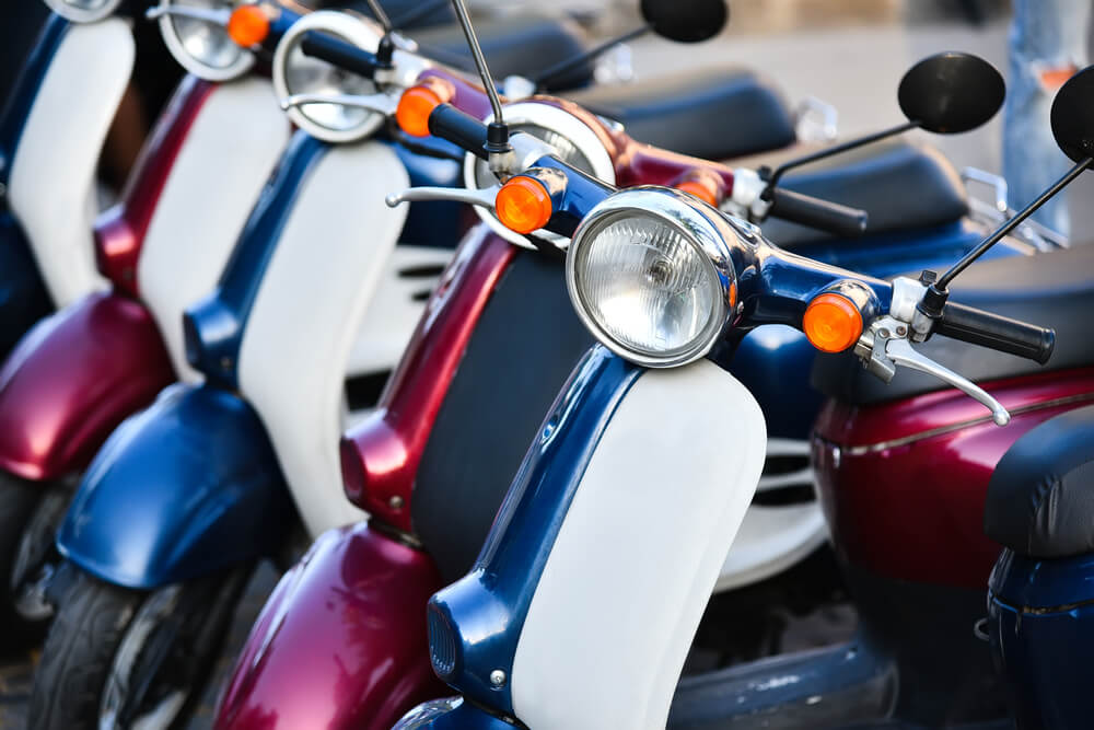 Parking mopeds of different colors.