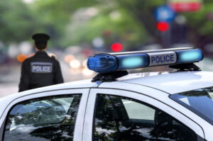 Police officers investigating the car accident.