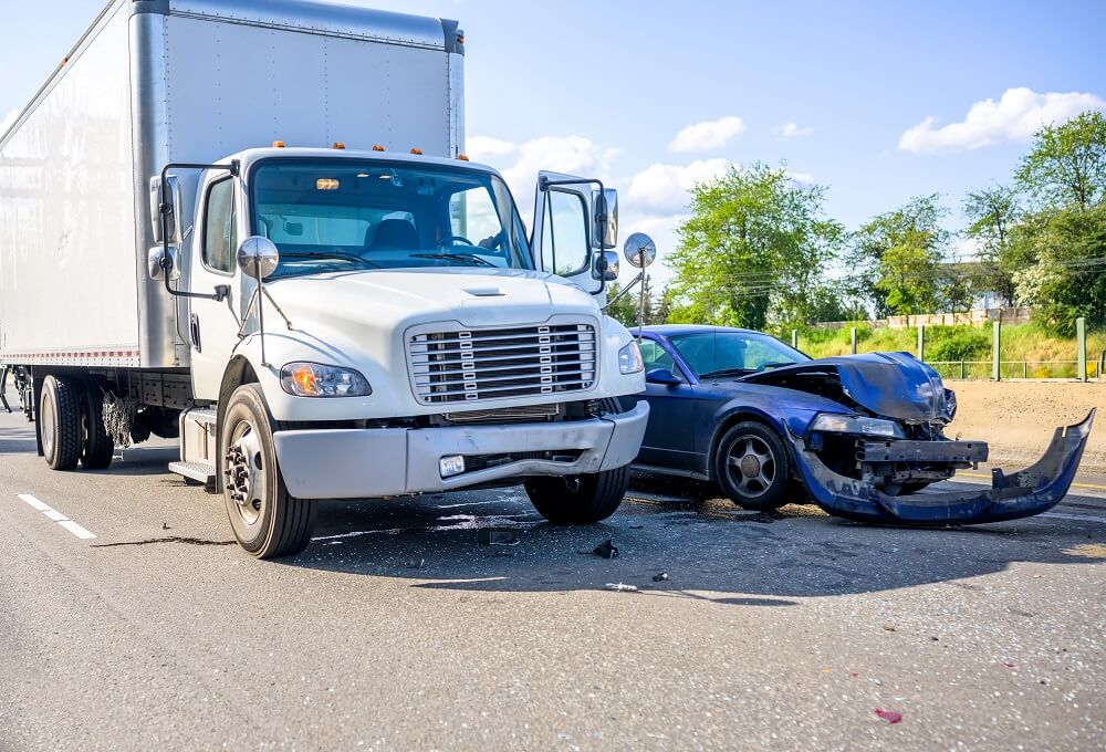 White truck and car collision in the highway