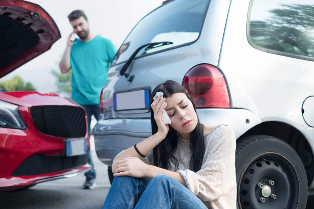 Lady driver suffering head injuries from car accident.