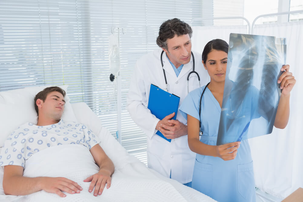 Doctor reading xray results of the injured patient.