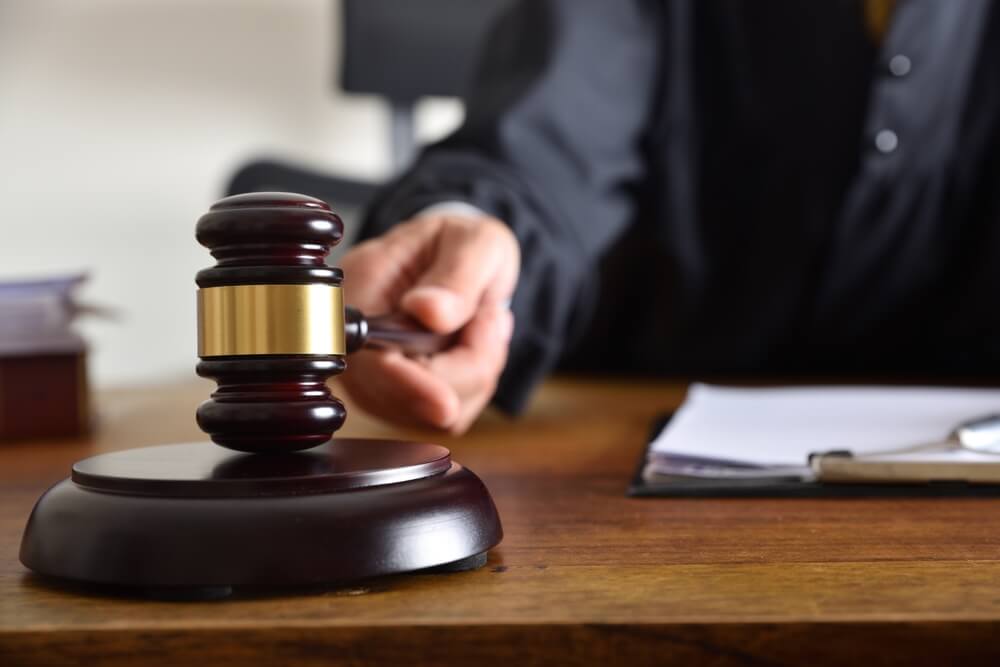 Judge on trial with gavel on his final verdict.