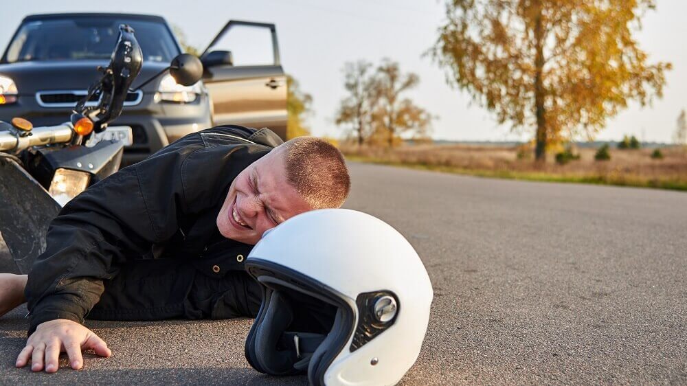 Motorcycle rider in pain from accident.
